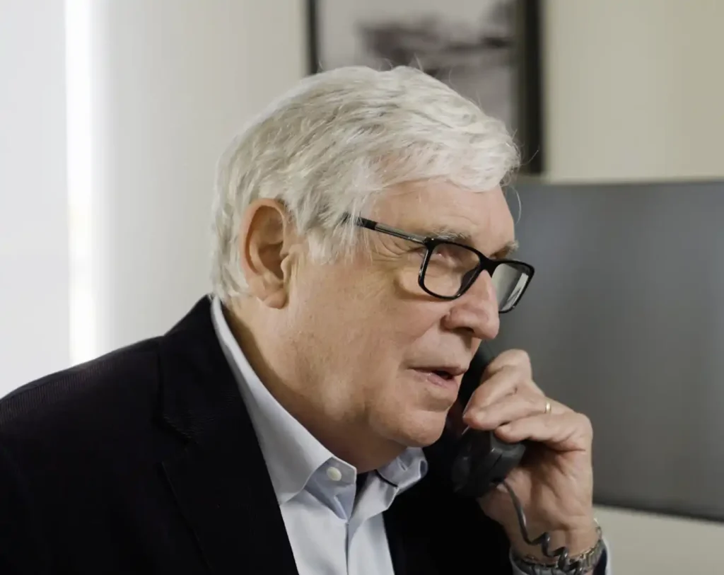 Michael Hackard on the phone with a client